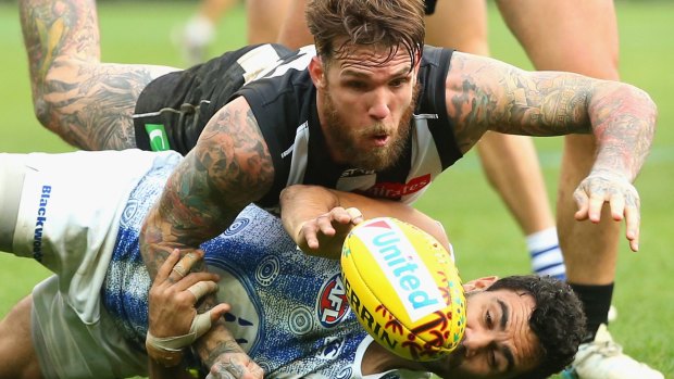 Dane Swan of the Magpies and Lindsay Thomas of the Kangaroos compete for the ball during the round nine match on Sunday.