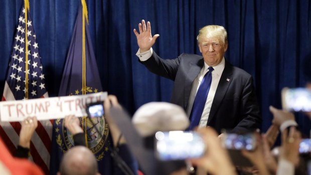 Donald Trump takes the stage to speak to supporters during a primary night rally on Tuesday.