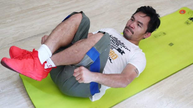 Crunch time: Pacquiao busts out one of 2600 ab crunches for the day in his Manila mansion.