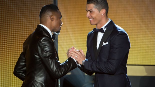 Close, but no cigar: Ballon d'Or 2014 winner Cristiano Ronaldo shakes hands with former Barcelona striker Samuel Eto'o.