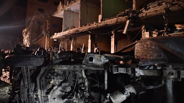 People gather in the aftermath of a multiple explosions in the Sayyida Zeinab area, 10km south of Damascus, Syria, on Sunday.