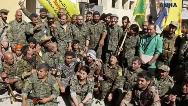 Fighters from the US-backed Syrian Democratic Forces (SDF) celebrating their victory in Raqqa, Syria.