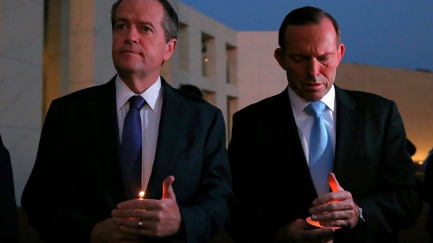Opposition Leader Bill Shorten and Prime Minister Tony Abbott during a candlelight vigil for Andrew Chan and Myuran Sukumaran on the forecourt of Parliament House in Canberra on Thursday.