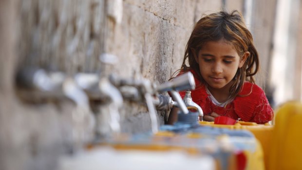 A girl fills a container with water from a public tap amid an acute shortage of water, in the old city of Sanaa, Yemen, on Wednesday. 