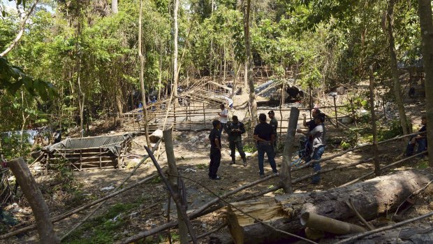 Rescue workers inspect the abandoned camp in Thailand's southern Songkhla province.
