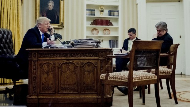 Mr Trump's national security adviser Michael Flynn, cenre, and chief strategist Steve Bannon listen in on the President's phone call with Mr Turnbull.