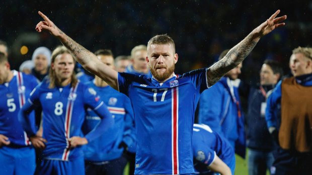 Iceland's captain Aron Gunnarsson celebrates his country's World Cup qualification, leading the 'Viking Clap'.