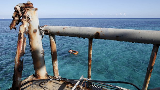 A newly deployed Philippine Marine, part of a military detachment stationed aboard the BRP Sierra Madre, fishes near the ship in the disputed Second Thomas Shoal, part of the Spratly Islands in the South China Sea in this photo taken last year. 