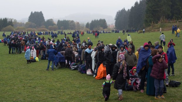 Refugees wait at the German-Austrian border near Wegscheid on Thursday.