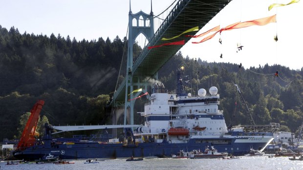 The Royal Dutch Shell PLC icebreaker Fennica heads up the Willamette River under protesters hanging from the St Johns Bridge on its way to Alaska.