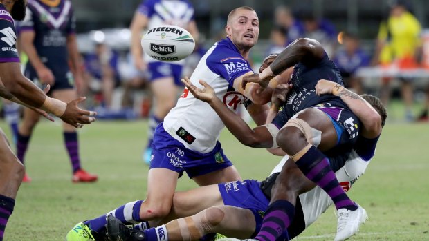 Slipped away: Suliasi Vunivalu offloads under pressure from new Canterbury recruit Kieran Foran.