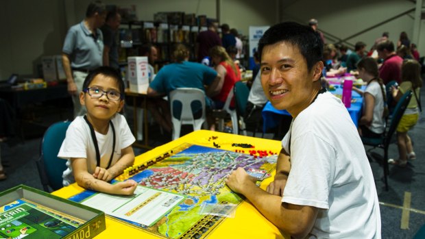 Ronald and Chilok Yu, 6, of Gungahlin play Power Grid from the board game library.
