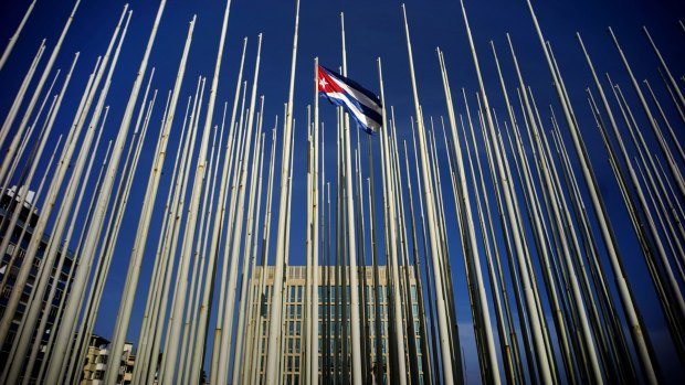 A Cuban flag flying near the US Interests Section building, behind in Havana on Sunday.