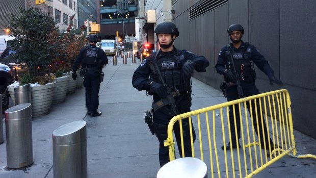 Police block off a footpath while responding to a report of an explosion near Times Square.