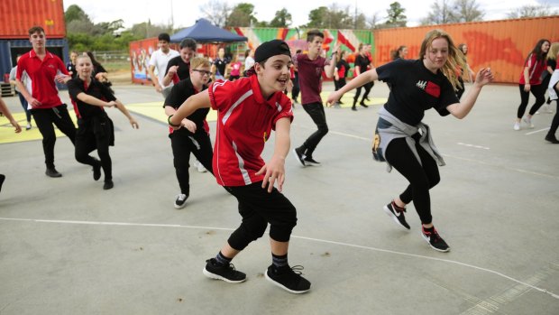 From left, Calwell High school year 10 students, Jacob Brown, 15, of Gilmore and Grace Forbes, 15, of Jerrabomberra take part in the outdoor dance jam held at the Westside Acton Park for the launch of Ausdance ACT Australian dance week in Canberra.