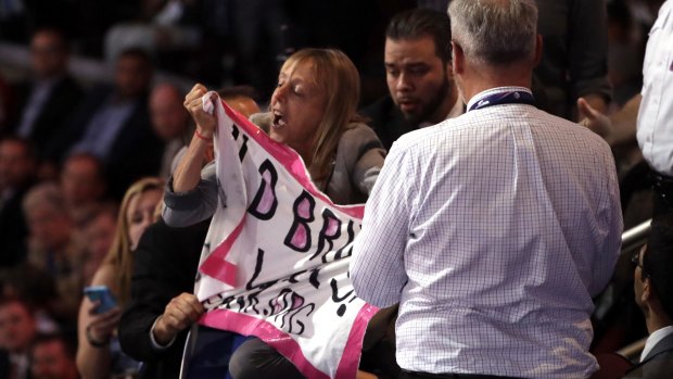 A protester is taken away as Donald Trump speaks.