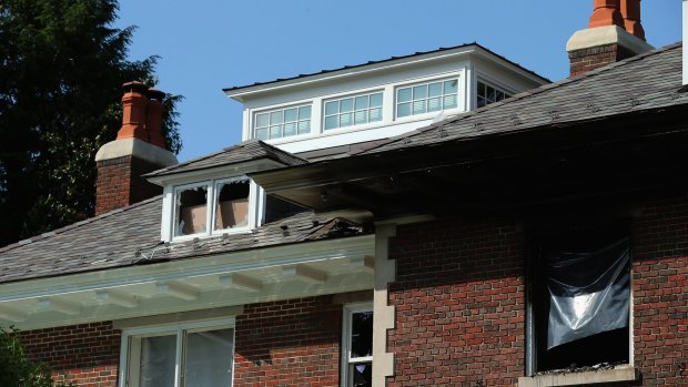 Smashed windows and heavy fire damage scar the Savopoulos  home.