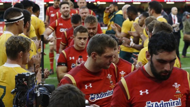 Dejected Wales players walk off the pitch following their 32-8 defeat.