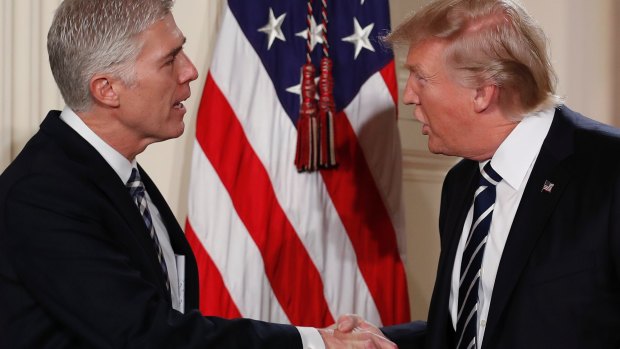 President Donald Trump shakes hands with Judge Neil Gorsuch on Tuesday.
