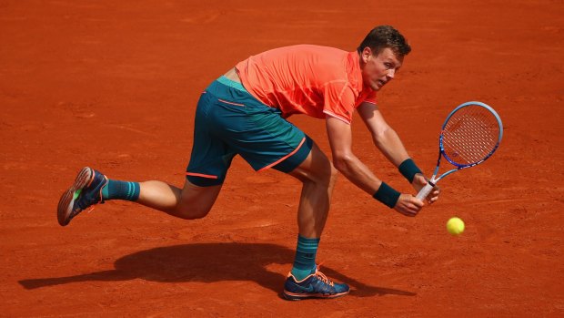 Tomas Berdych of the Czech Republic plays a backhand during his first-round match against Yoshihito Nishioka of Japan.