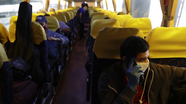 Crew from the AIDAsol cruise ship in Europe head home on a government-provided bus in Manila. In some cases it took two months to get through the quarantine processes of the countries involved.