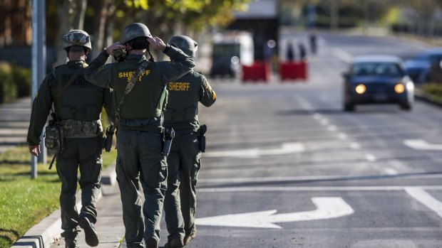 Merced County Sheriff SWAT members enter the University of California.