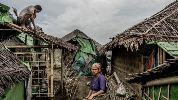A man fixes his roof in an area called "plastic camp," at a camp for Rohingya in Sittwe earlier this month. 