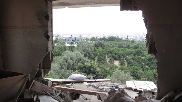 The damage caused by a heavy artillery shell. Alian Abu Jarad, 62, who lives next door, tried to rescue his family following the airstrike on July 18.