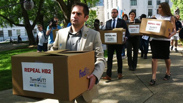 Executive director of Equality North Carolina, Chris Sgro, leads a group carrying petitions calling for the repeal of House Bill 2 to Governor Pat McCrory's office on Monday.  