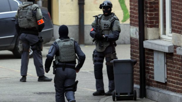 Special operations officers close down a street during a police raid in the Molenbeek neighbourhood of Brussels.