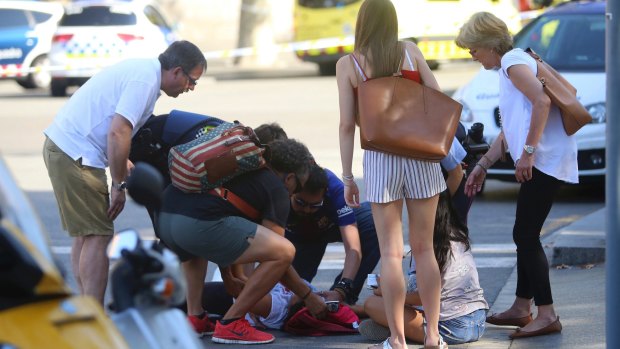 A person is treated in Barcelona after the van attack.
