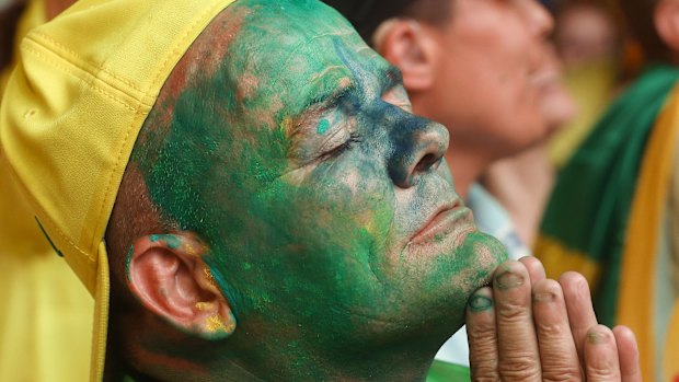 An anti-government demonstrator listens to the vote count, as legislators vote on whether or not to impeach President Dilma Rousseff. 