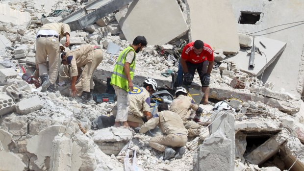Civil defence workers search for survivors.