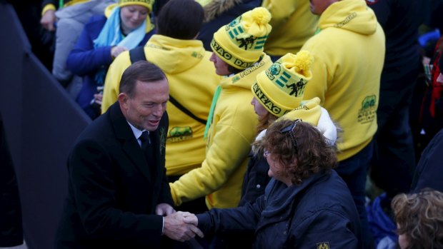 Prime Minister Tony Abbott shakes hands with Australians during the dawn ceremony at Anzac Cove on Saturday.