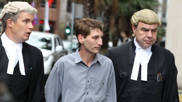 Jonathan Moylan (centre) arrives for sentencing at the NSW Supreme Court on Friday.