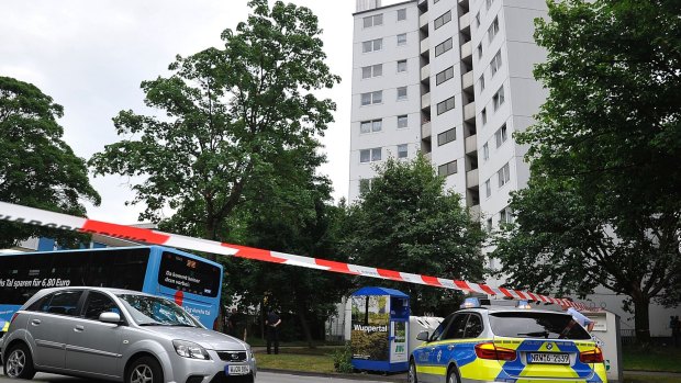 German police block entry to an apartment block in Wuppertal, on Tuesday.