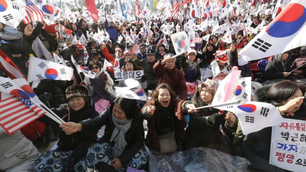 Supporters of South Korean President Park Geun-hye  gather outside court on Friday ahead of the ruling that removed her from office.