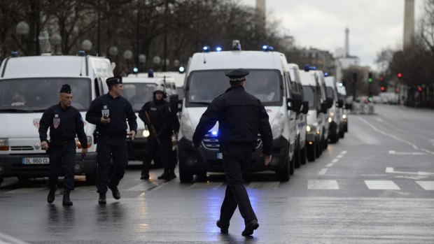 Police gather together at the Porte de Vincennes, east Paris, as they work to surround the grocery store.