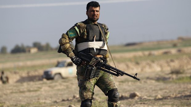 A Shi'ite fighter in al-Alam, north of Tikrit, in Iraq, where Iraqi security forces and Shi'ite fighters are battling Islamic State. 