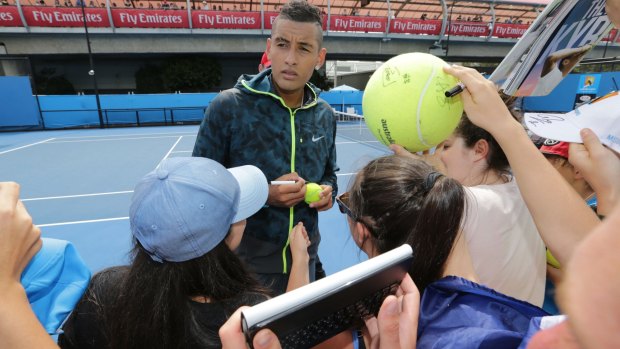 Nick Kyrgios signs autographs for fans during a practice session on Tuesday.