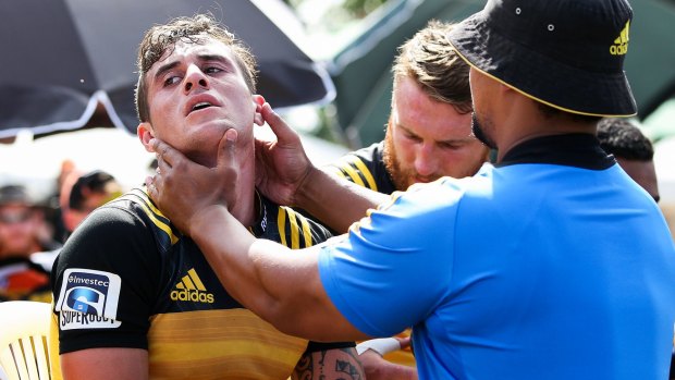 Close to the action: Hurricanes scrum-half TJ Perenara gets a pitchside check-up at the weekend.