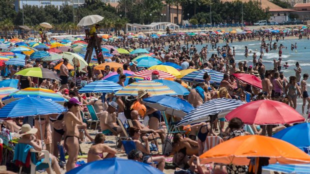 Locals hit the beach as temperatures soar in Spain. 