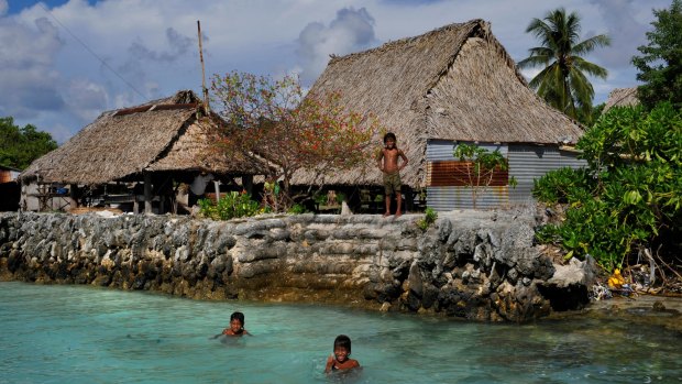 The village of Tebunginako in the Kiribati islands had to move because of rising seas and erosion. The new village (pictured) is now under threat of inundation and sea walls have to be constantly maintained.
