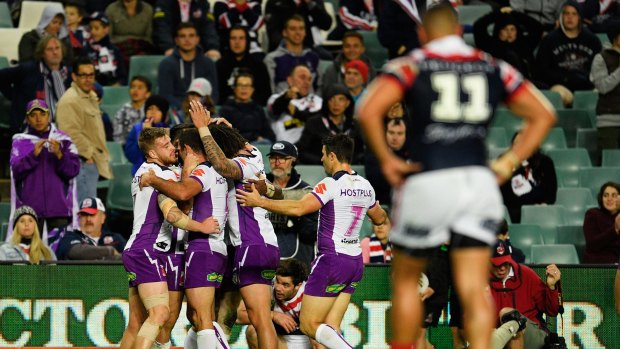 No mercy rule: Storm players celebrate another try in the 46-0 belting of the Roosters.