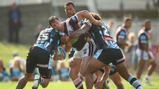 Comeback trail: Brenton Lawrence is tackled during the trial match between the Cronulla Sharks and the Manly Sea Eagles at Shark Park.