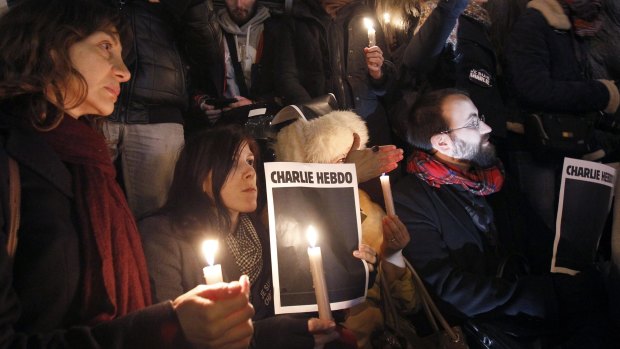 Watch this space: Women hold candles and blank front pages of <i>Charlie Hebdo</i> during a gathering at the Place de la Republique in support of the victims after the terrorist attack.