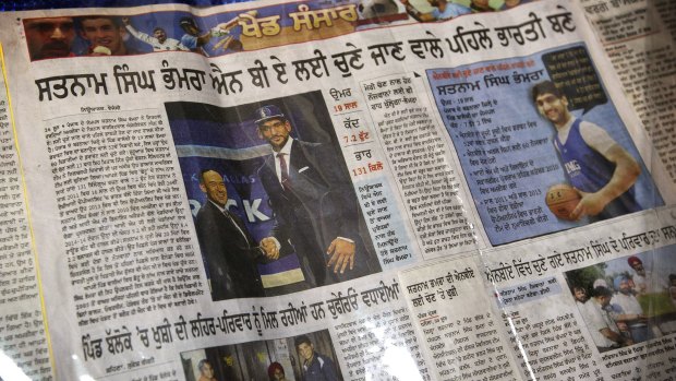 A laminated Indian newspaper article about Satnam Singh Bhamara's selection by the Dallas Mavericks at his family's home in Ballo Ke earlier this month. 