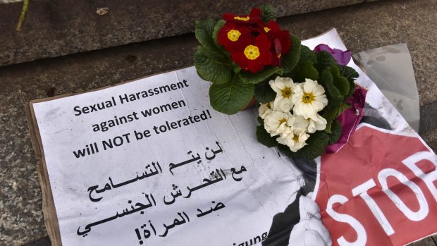 A banner with flowers is placed on the steps to the Cologne cathedral. 