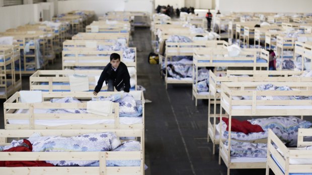 A new temporary shelter for migrants and refugees at a fair grounds hall in Berlin.