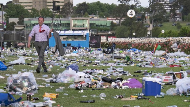 Racegoers leave Flemington a huge mess, leaving the last to go to wade through an ocean of rubbish.